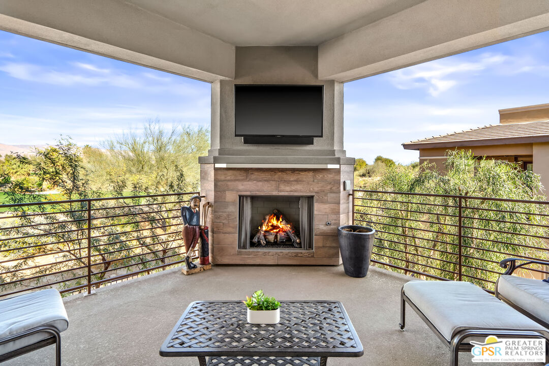 204 Retreat Circle Palm Desert, CA 92260 - Photo 4 of 60 a living room with furniture a rug and a fireplace