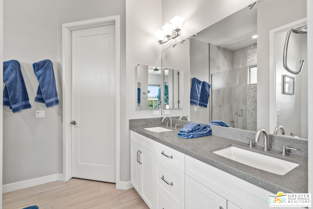 204 Retreat Circle Palm Desert, CA 92260 - Photo 49 of 60 a bathroom with double vanity sinks and a mirror