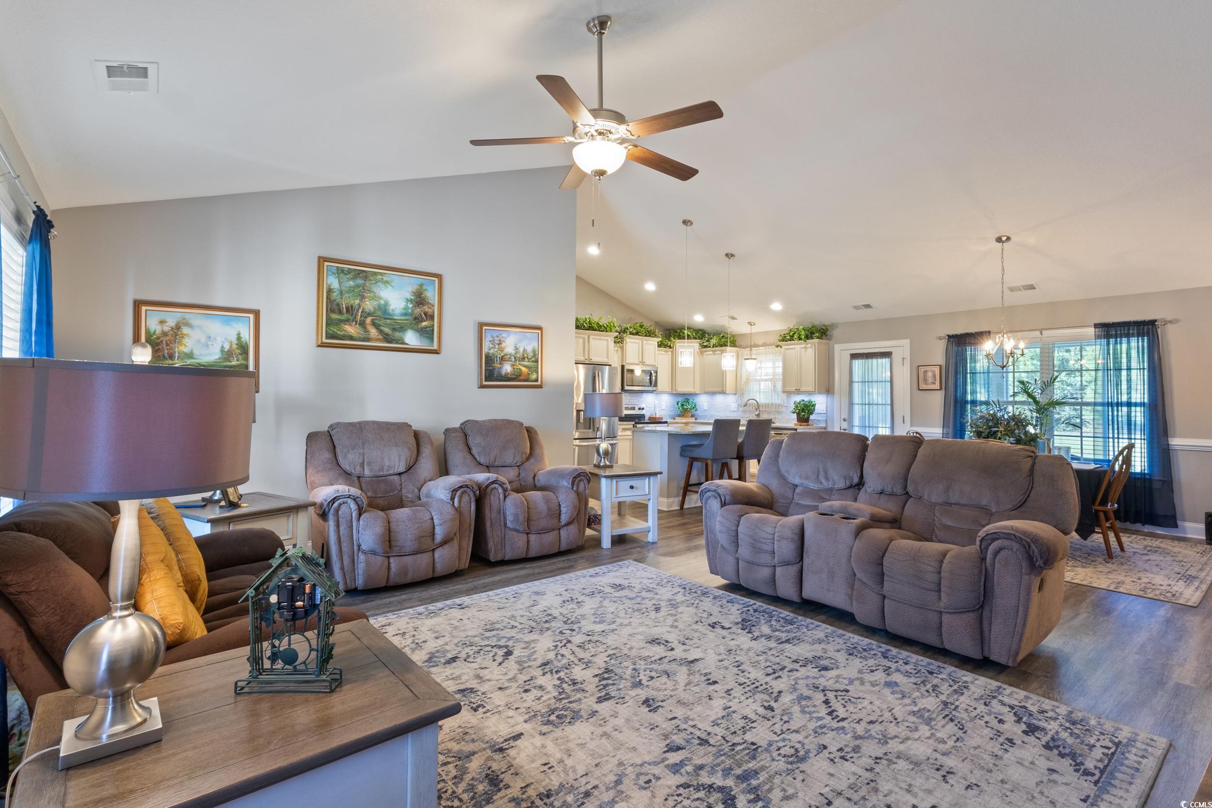 1353 Hucks Road Aynor, SC 29511 - Photo 11 of 40 Living room featuring wood finished floors, a chandelier, a ceiling fan, and high vaulted ceiling