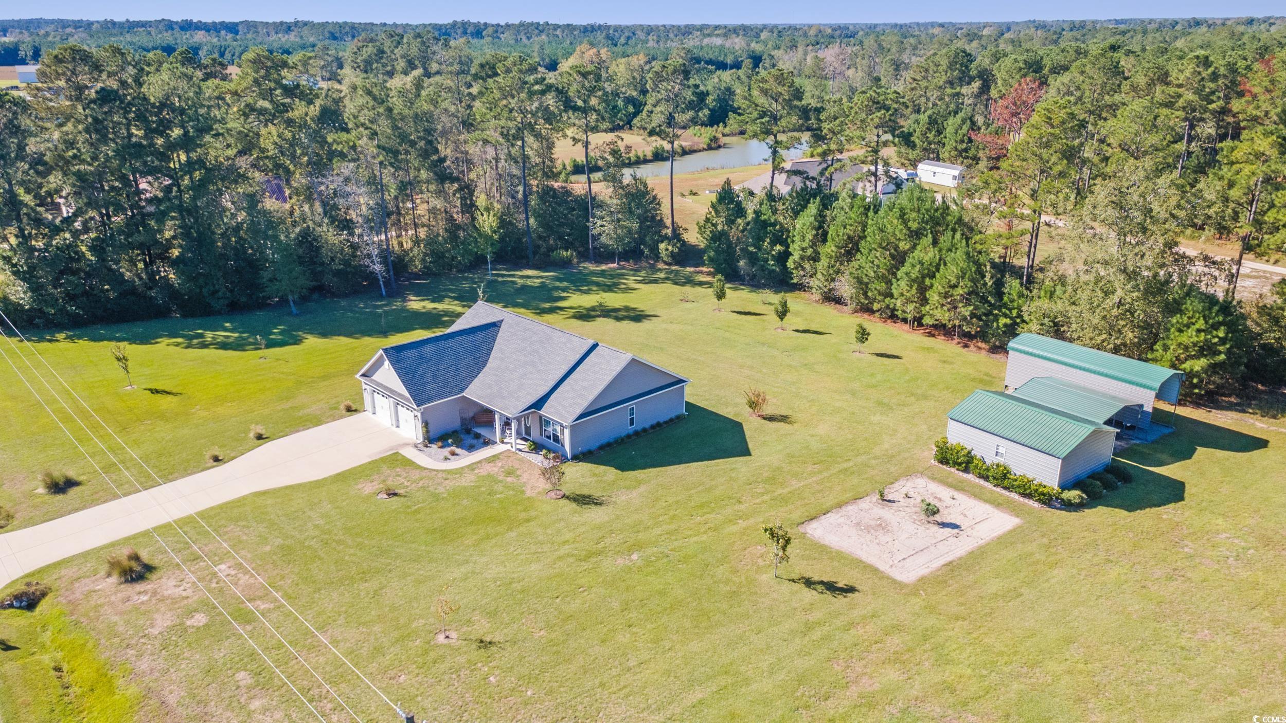 1353 Hucks Road Aynor, SC 29511 - Photo 3 of 40 View from above of property with a heavily wooded area