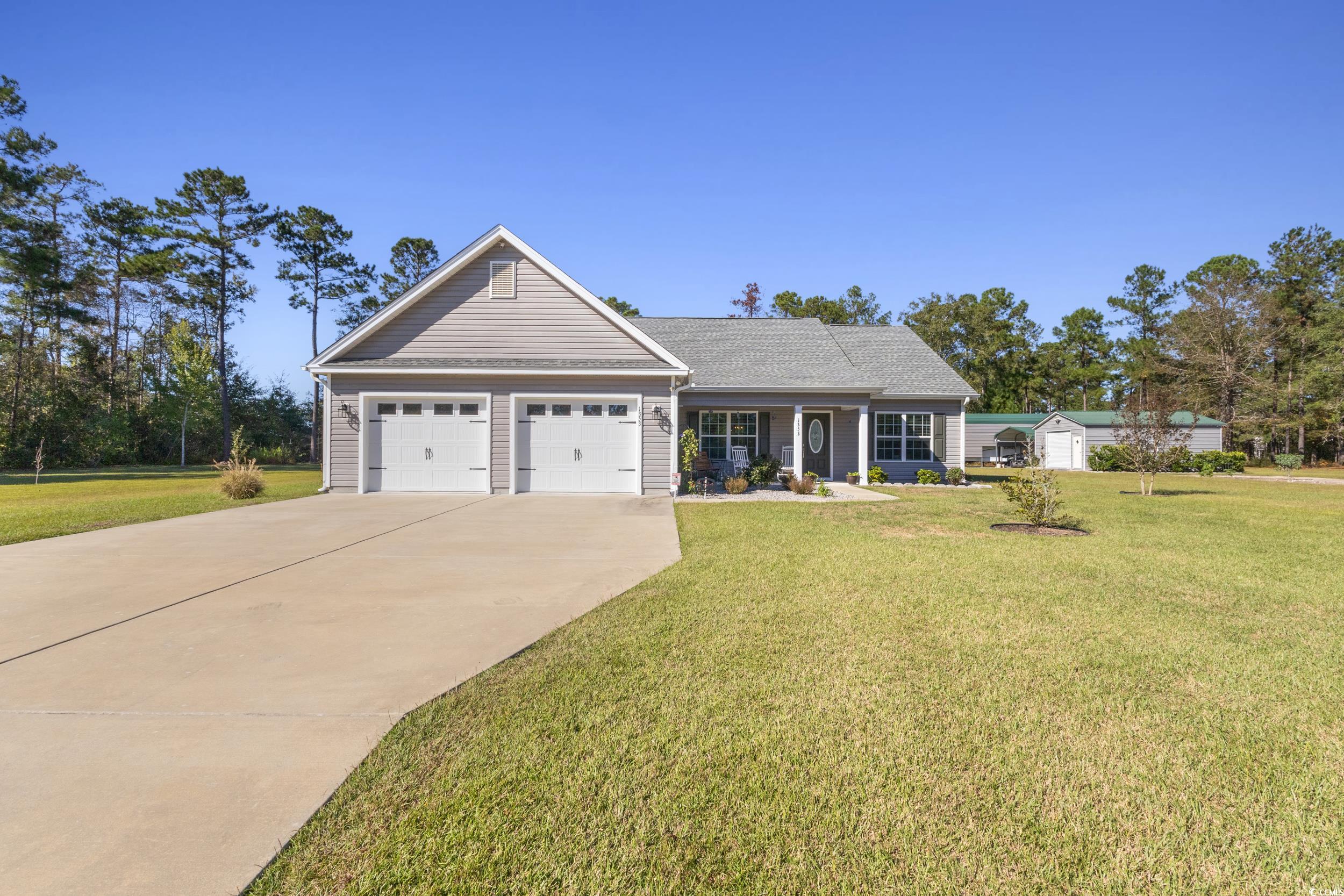1353 Hucks Road Aynor, SC 29511 - Photo 6 of 40 View of front of property featuring concrete driveway, a front lawn, covered porch, and an attached garage