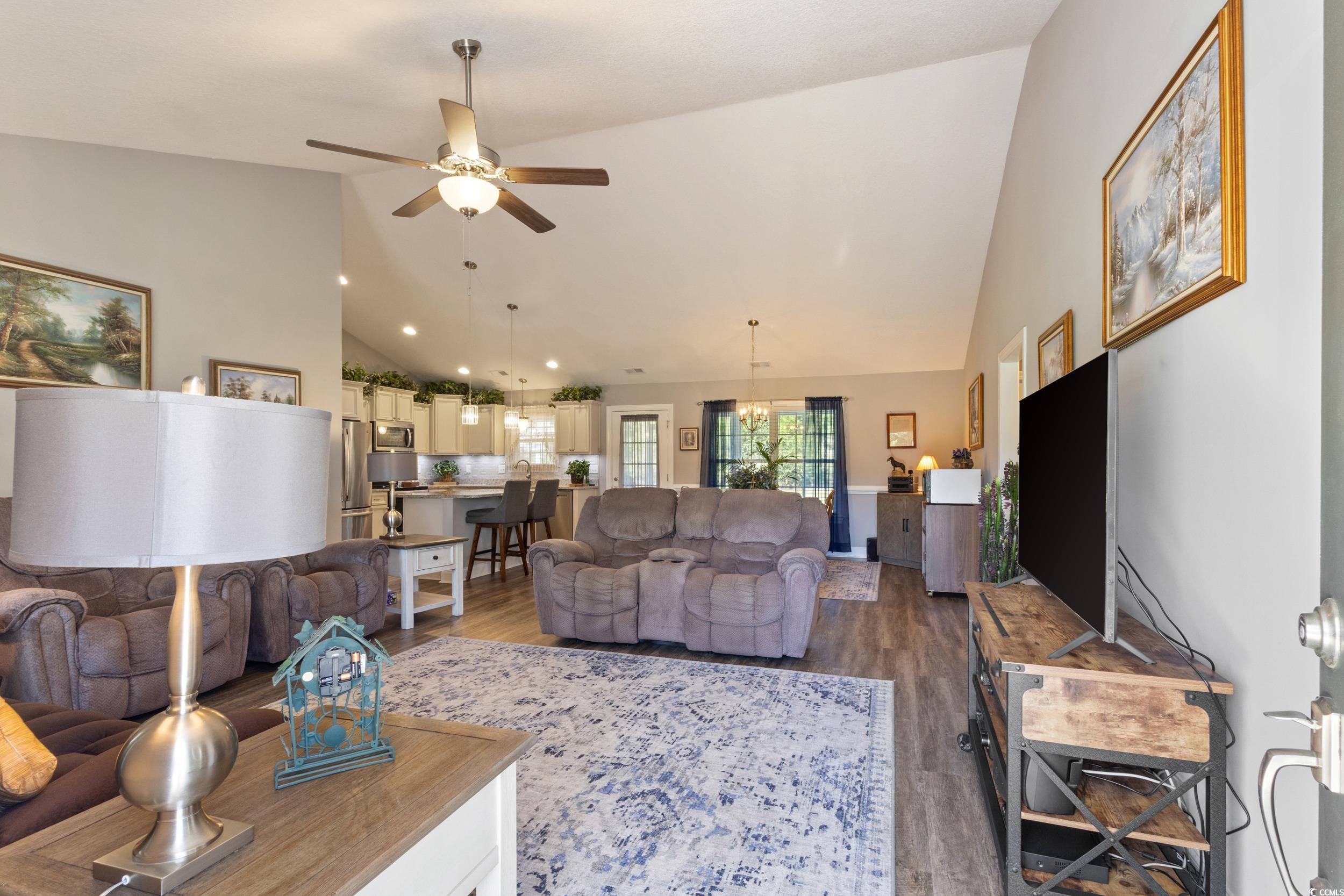 1353 Hucks Road Aynor, SC 29511 - Photo 10 of 40 Living room featuring high vaulted ceiling, dark wood-type flooring, ceiling fan, and a chandelier
