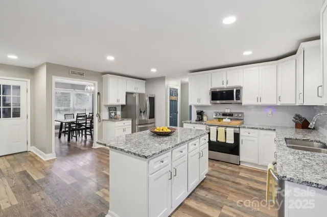 a kitchen with a sink stove top oven and refrigerator