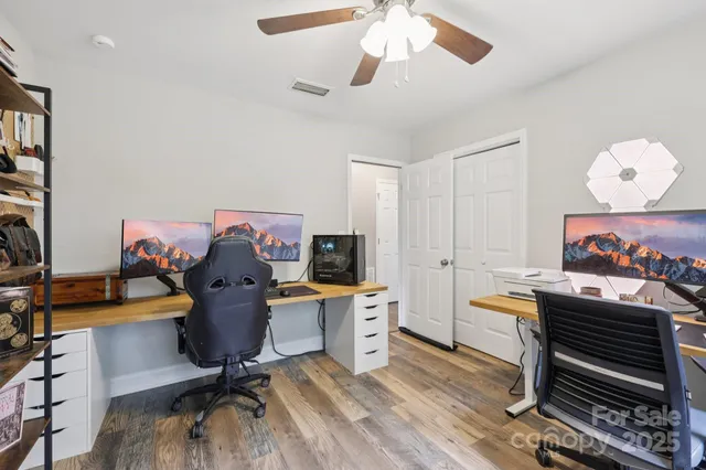 a bathroom with a granite countertop double vanity sink and a mirror