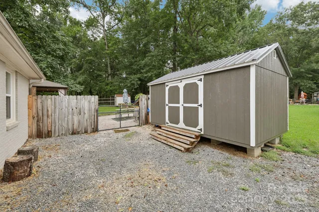 a view of a house with yard and sitting area