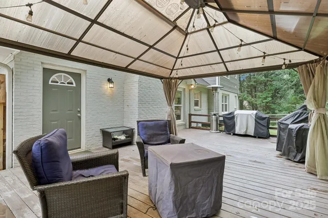 a view of a patio with a table chairs and a backyard