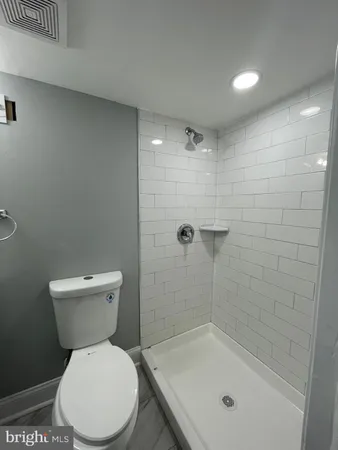 a bathroom with a toilet and a shower