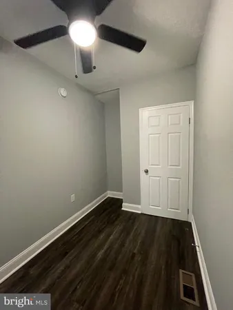 a view of an empty room and wooden floor
