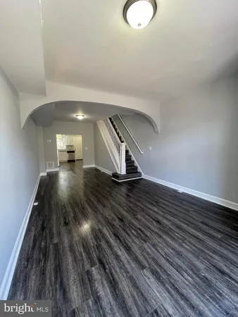 a view of a room with wooden floor