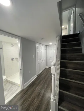 a view of entryway and gallery with wooden floor