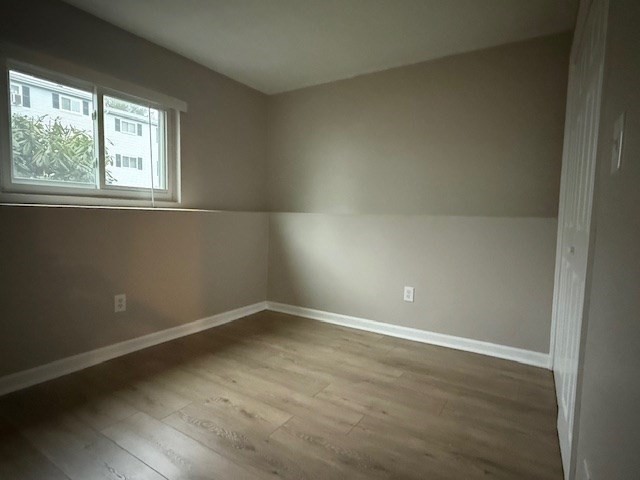 5455 North Main Street, Unit 12A Fall River, MA 02720 - Photo 13 of 16 an empty room with wooden floor and windows