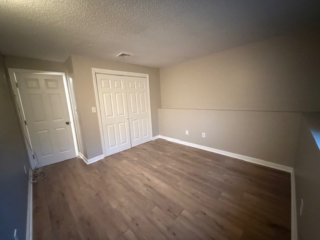 5455 North Main Street, Unit 12A Fall River, MA 02720 - Photo 15 of 16 an empty room with wooden floor and mirror