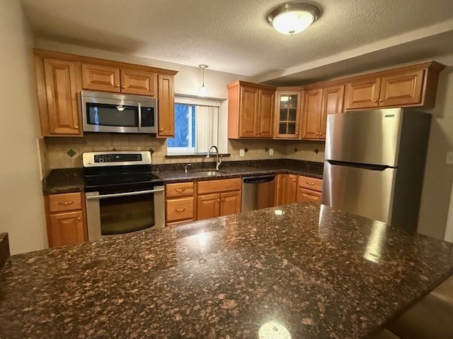 5455 North Main Street, Unit 12A Fall River, MA 02720 - Photo 3 of 16 a kitchen with a refrigerator a stove top oven a sink and dishwasher