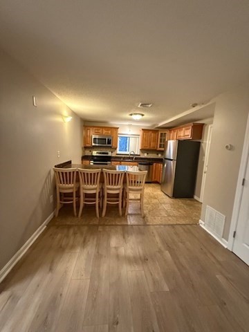 5455 North Main Street, Unit 12A Fall River, MA 02720 - Photo 9 of 16 a room with wooden floor and furniture