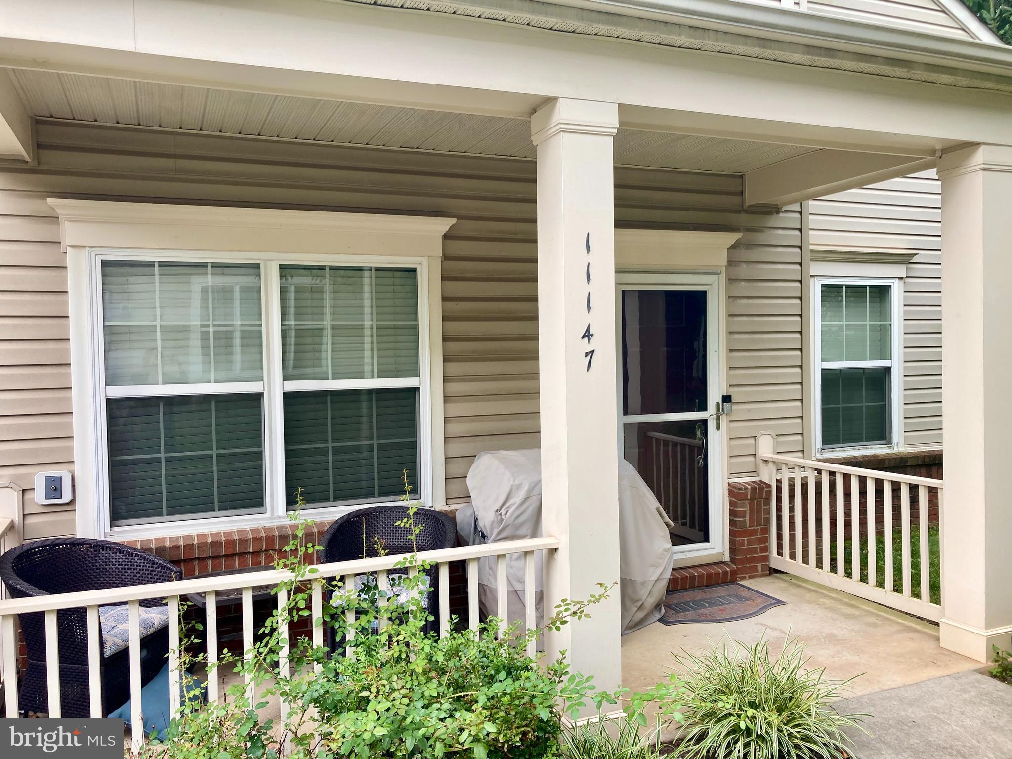a view of a house with a window and wooden fence