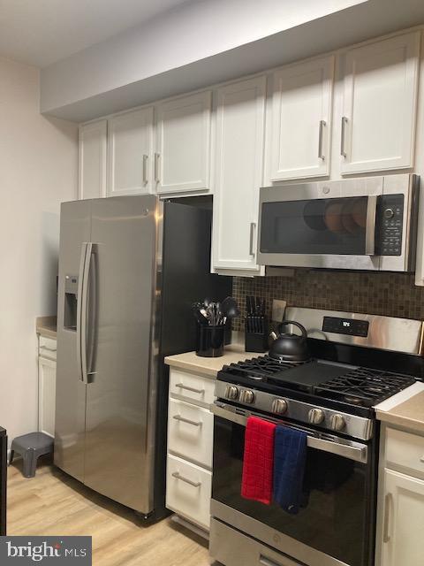 11147 Wortham Crest Circle Manassas, VA 20109 - Photo 4 of 8 a kitchen with stainless steel appliances a stove a sink and a refrigerator