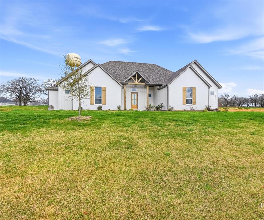 1005 Ronnie Court Springtown, TX 76082 - Photo 2 of 27 Contemporary white brick exterior with a dark shingle roof