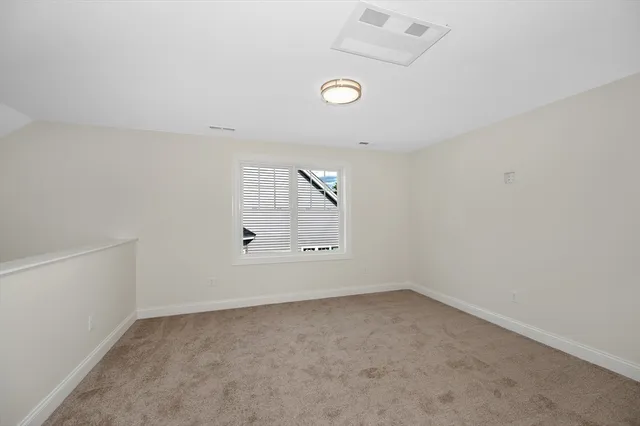 an empty room with a empty space and windows