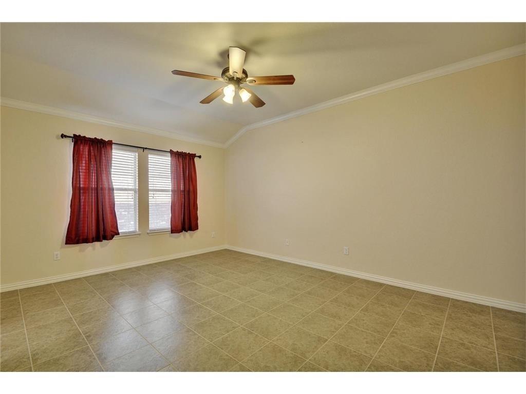 2109 Granite Springs Road Leander, TX 78641 - Photo 12 of 30 A well-lit room showcases durable tile flooring and a functional ceiling fan.