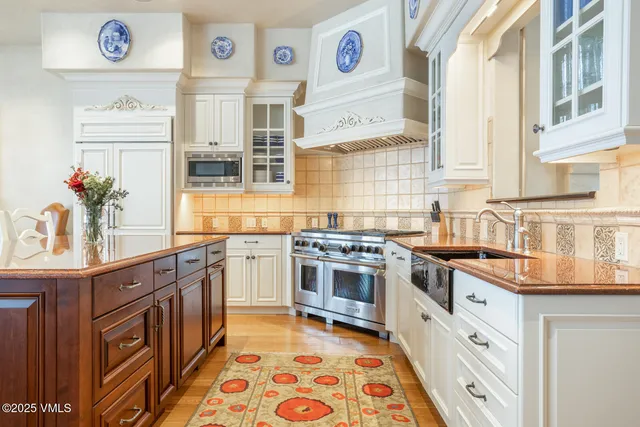 a kitchen with stainless steel appliances granite countertop a stove and a sink