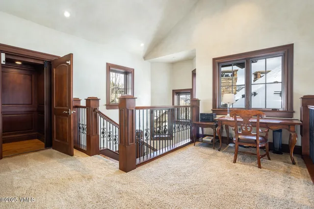 a view of a workspace with furniture and window