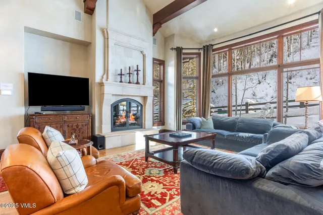 a living room with fireplace furniture and a flat screen tv
