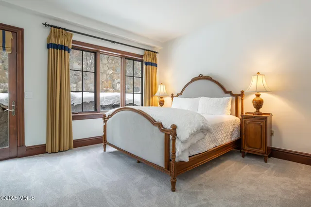 a spacious bedroom with a bed and a table