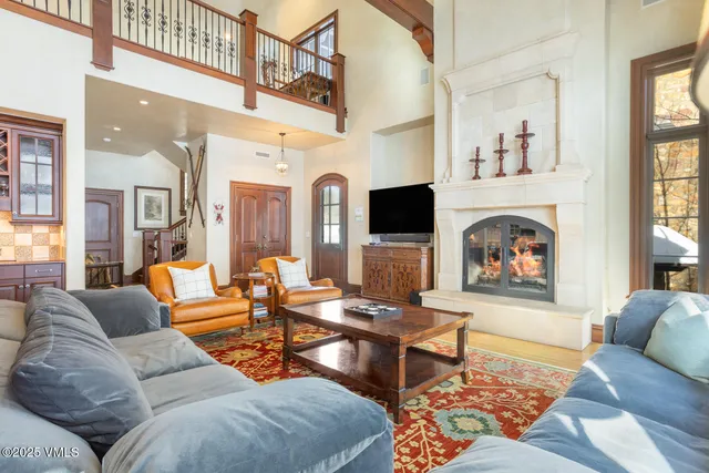 a living room with fireplace furniture and a flat screen tv