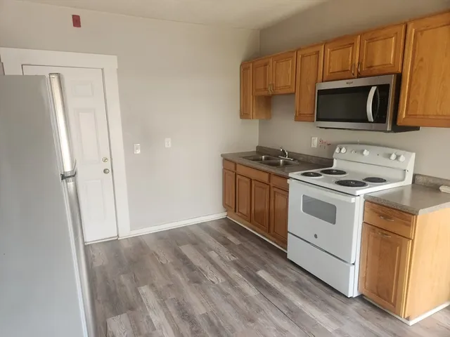 a kitchen with a stove microwave and sink