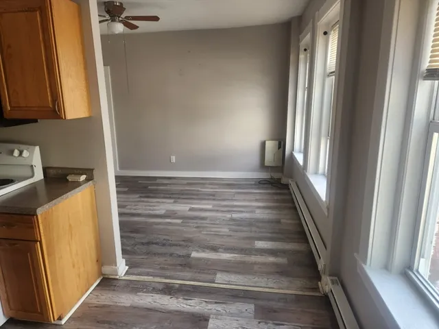 a view of an entryway with wooden floor