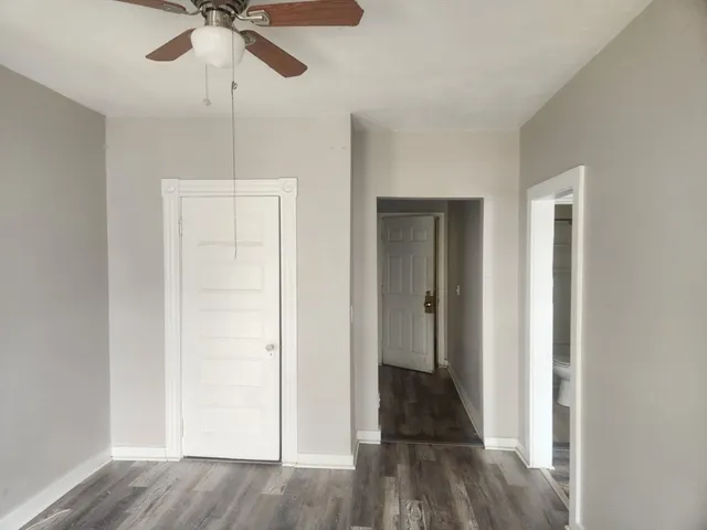 a view of a hallway with wooden floor and entryway