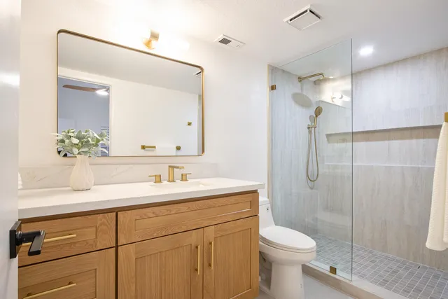 an empty room with a ceiling fan and a window