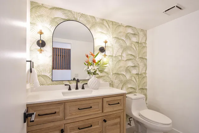 a front view of a house with garden and porch