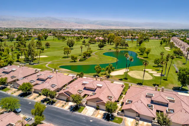an aerial view of a house with a lake view