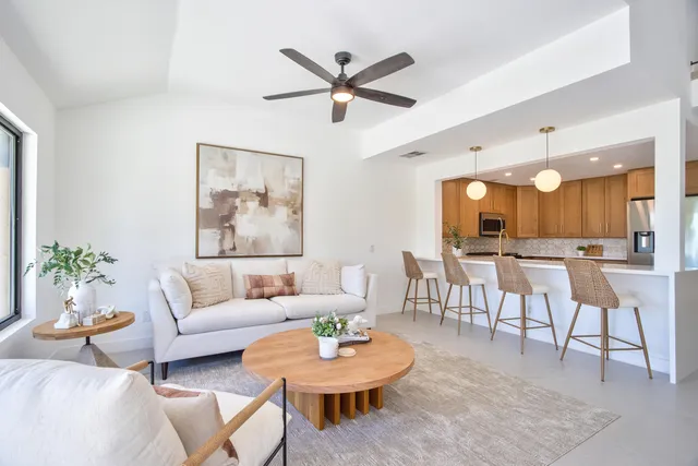 a kitchen with kitchen island granite countertop a sink and refrigerator