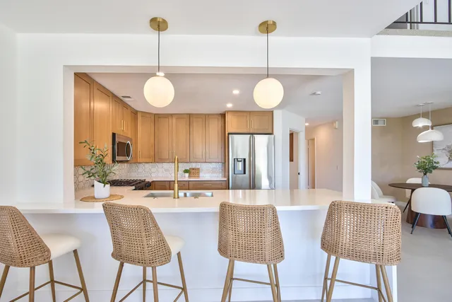 a large kitchen with a table and chairs
