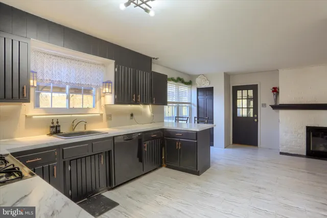 a kitchen with stainless steel appliances granite countertop a sink and cabinets