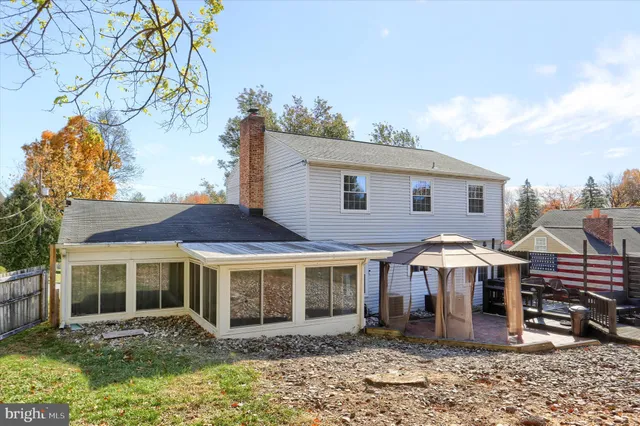 a view of a house with a yard and sitting area