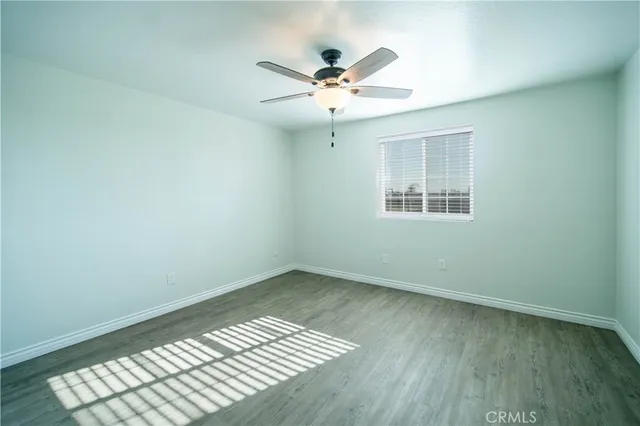 a bathroom with a granite countertop sink toilet a mirror and shower