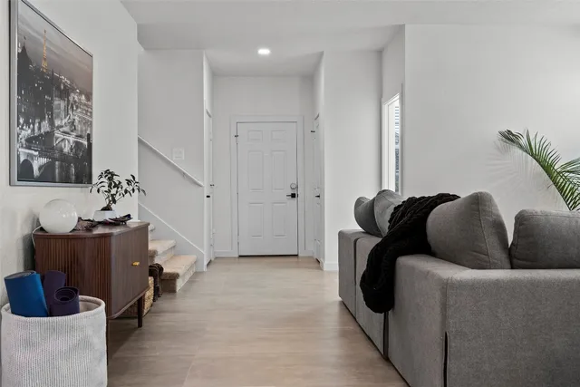 a living room with furniture and wooden floor
