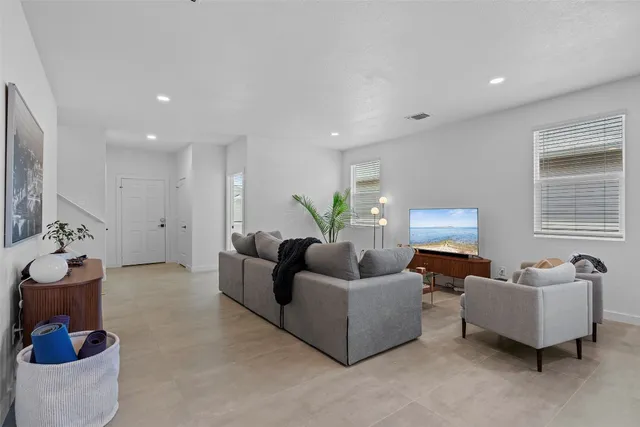 a living room with furniture and a lamp