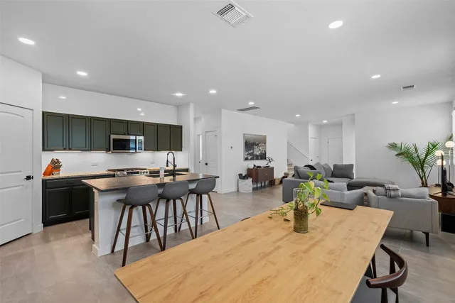 a large kitchen with a table and chairs