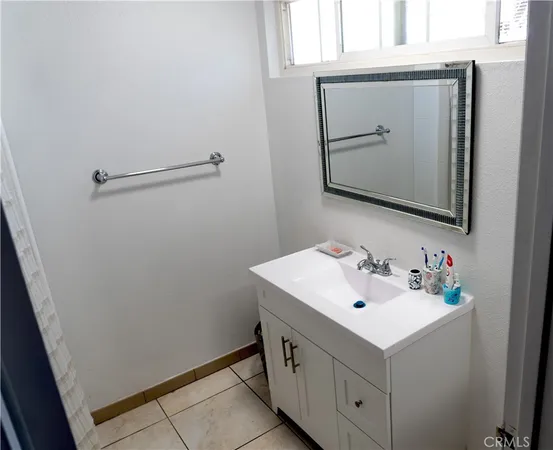 a bathroom with a sink vanity and mirror