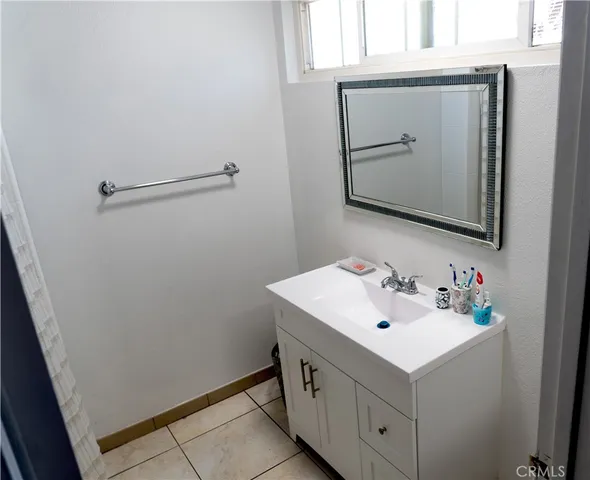 a bathroom with a sink vanity and mirror