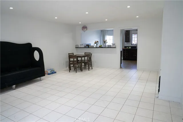 a view of kitchen with furniture and refrigerator