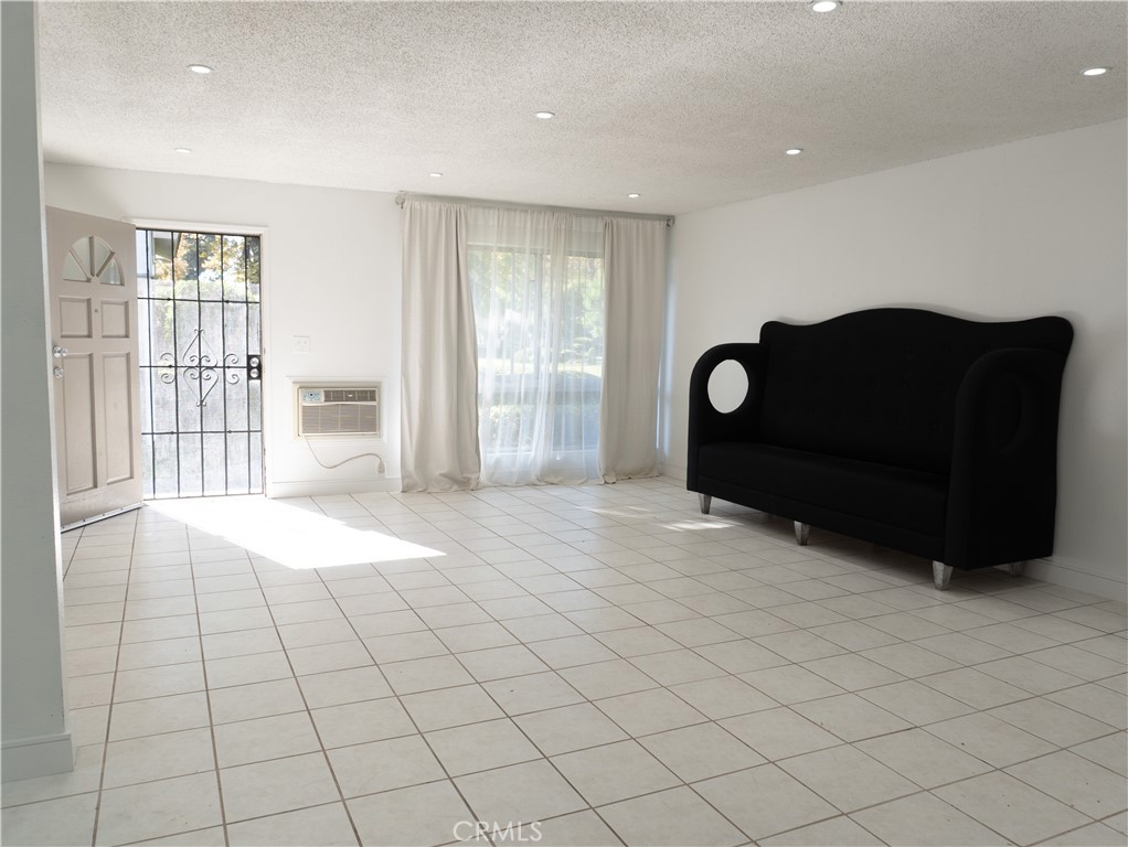 14802 Newport Avenue, Unit 2B Tustin, CA 92780 - Photo 3 of 13 a view of livingroom with furniture and window
