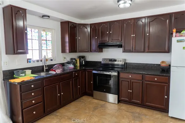 a kitchen with black cabinets and black appliances