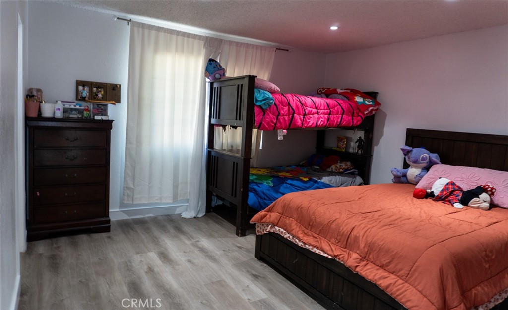 14802 Newport Avenue, Unit 2B Tustin, CA 92780 - Photo 8 of 13 a bedroom with a bed and a closet