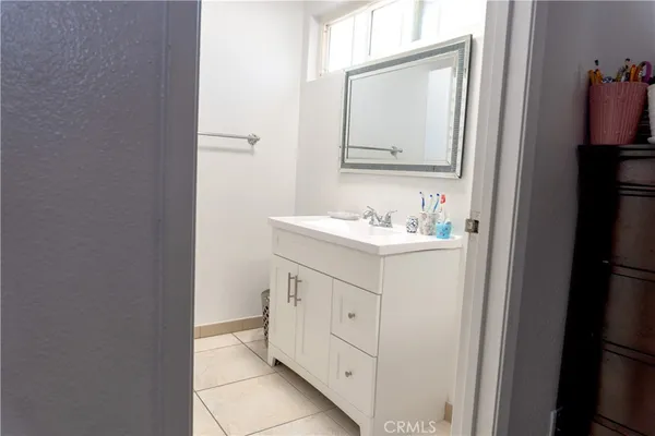 a bathroom with a sink vanity and a mirror