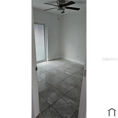 a view of a room with a ceiling fan